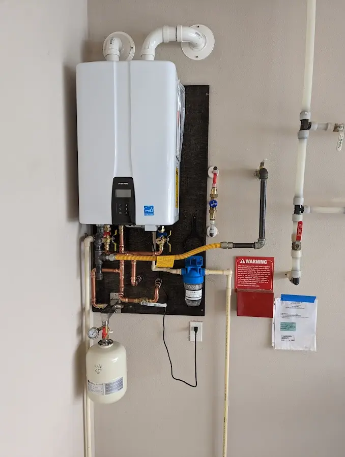 Professional plumber installing copper piping in a Grand Forks home